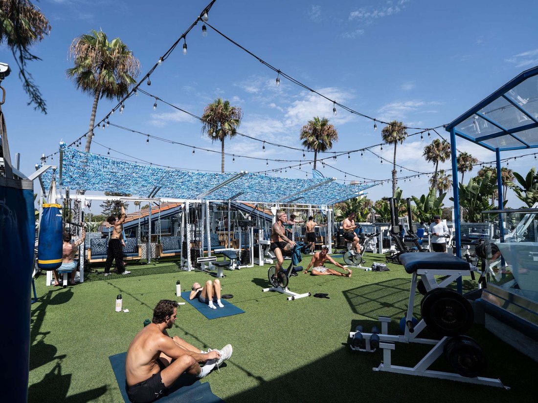 Rooftop Ocean-Oasis turf training deck with palms and string lights