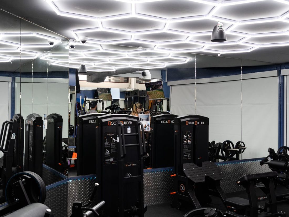 Booty Builder glute machines under hex lighting